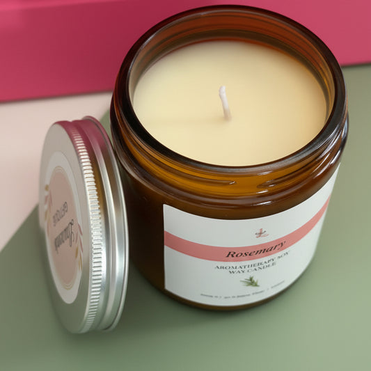 Candle in a glass jar with a label on a pink background