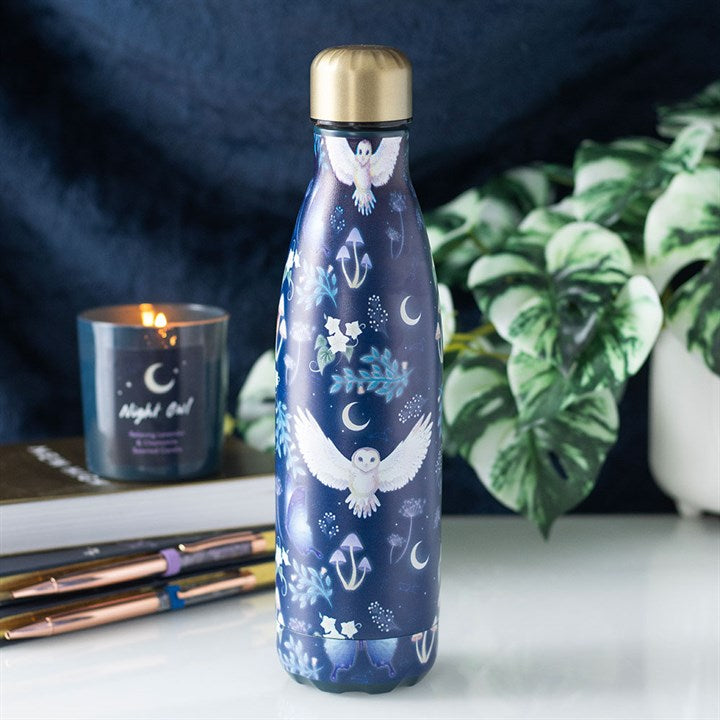 Navy insulated metal water bottle with mystical white owl, crescent moon and botanical print, gold lid, styled with a candle and plant
