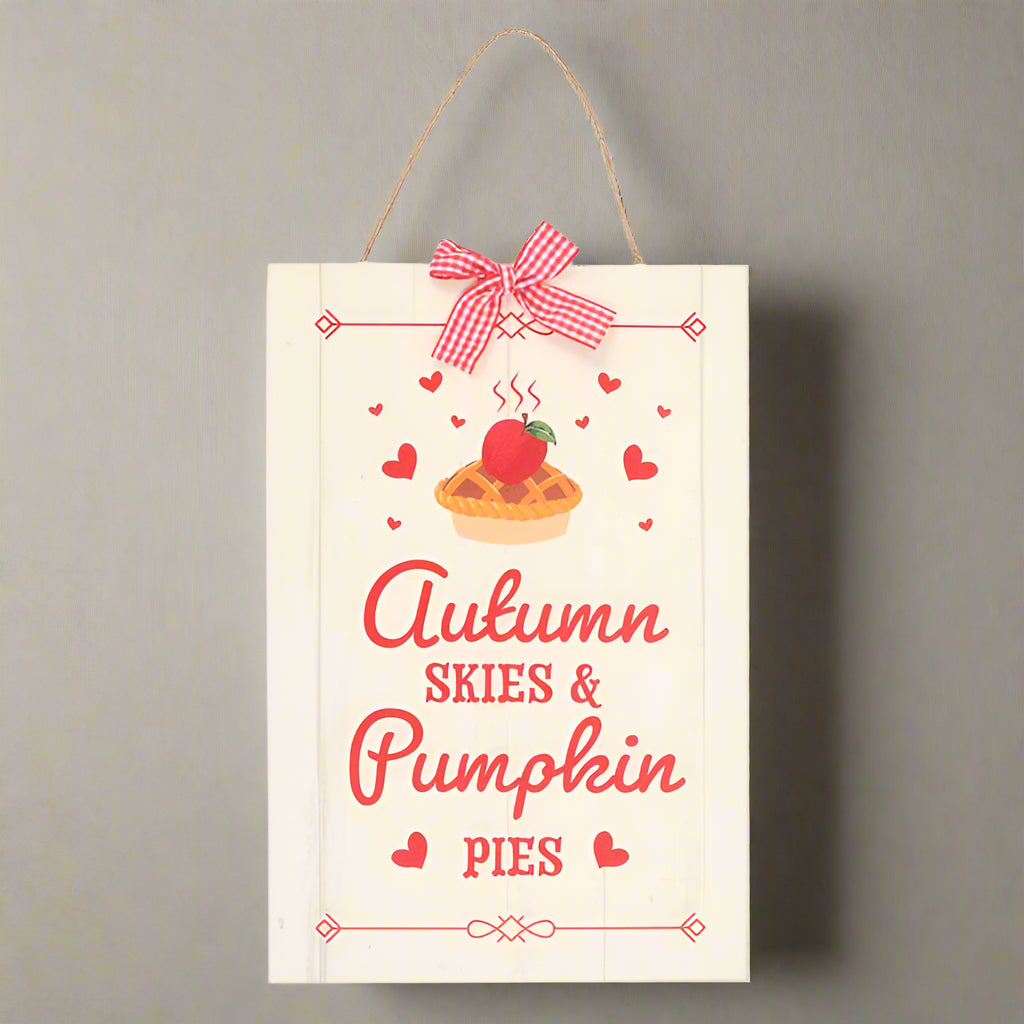 Decorative sign with a pumpkin pie illustration and text 'Autumn Skies & Pumpkin Pies' on a white background.