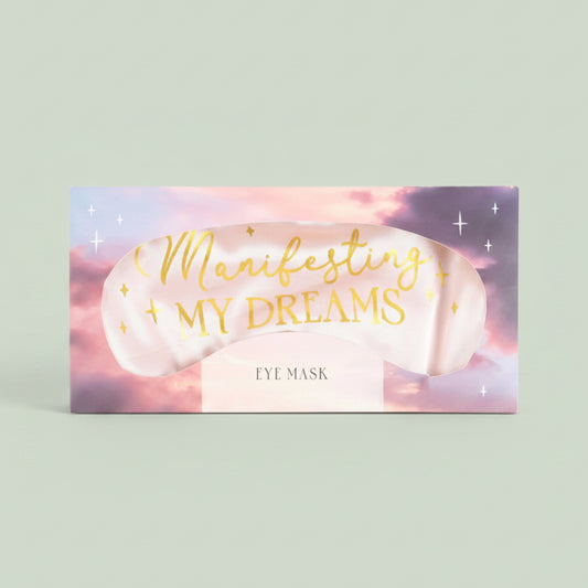 Eye mask with 'Manifesting My Dreams' text on a pastel background