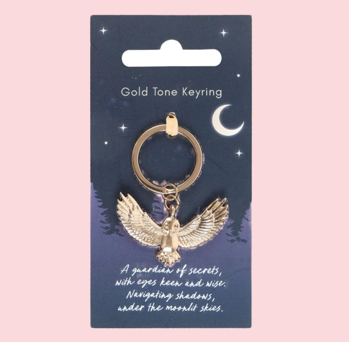 Gold tone keyring with owl design on a blue card with celestial illustrations