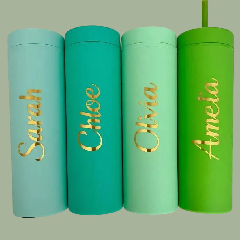 Four colorful tumblers with gold names on a light green background