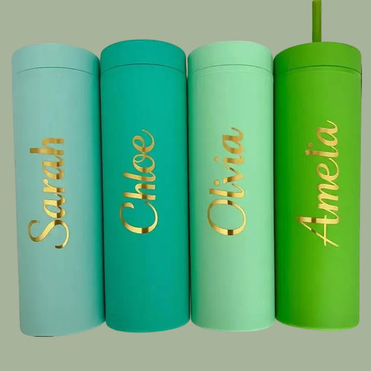 Four colorful tumblers with gold names on a light green background