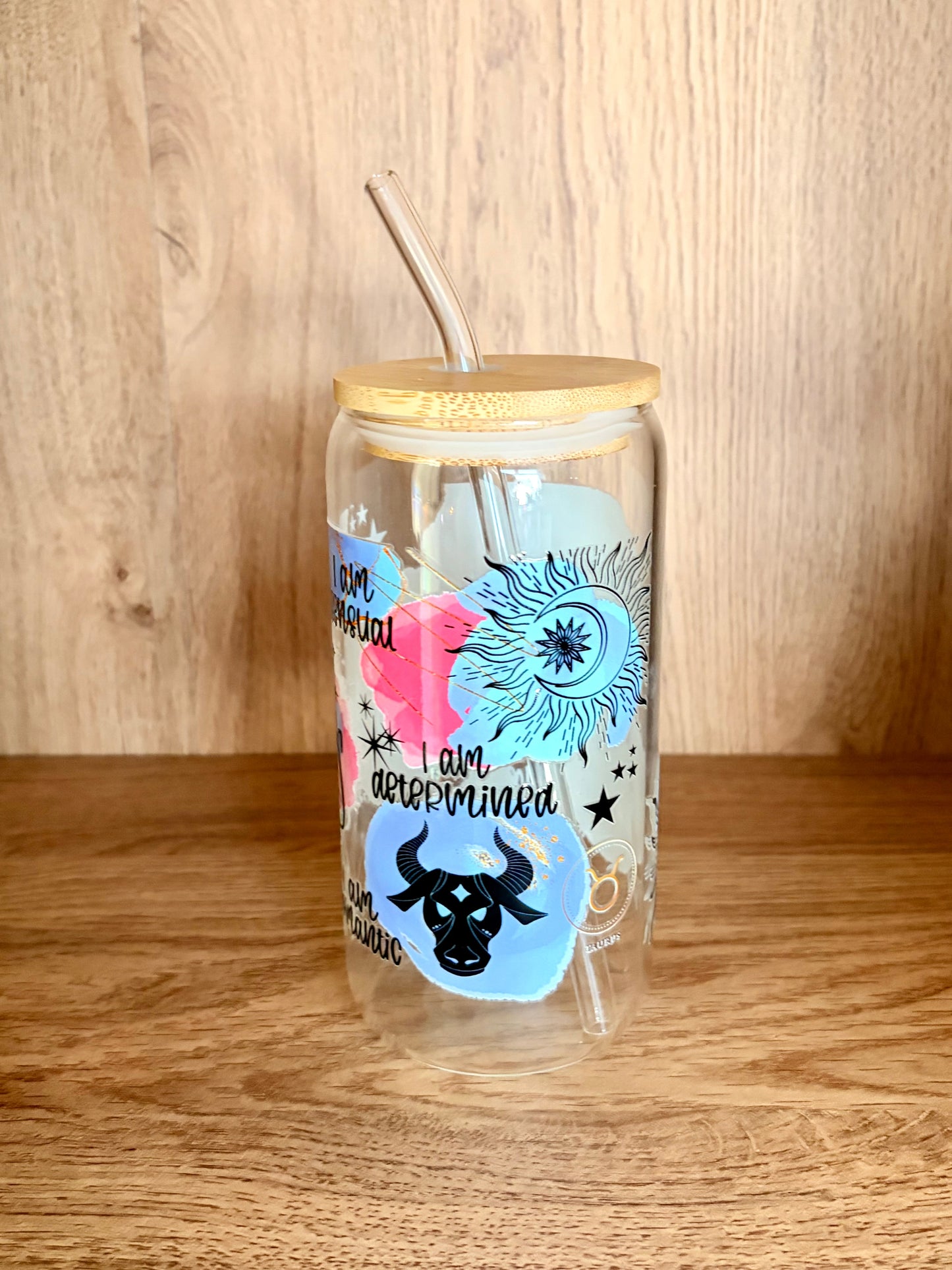 Taurus zodiac glass can showing I am determined affirmation with bull motif and sun and moon illustration