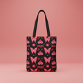 black tote bag with red and pink butterfly print on a red background