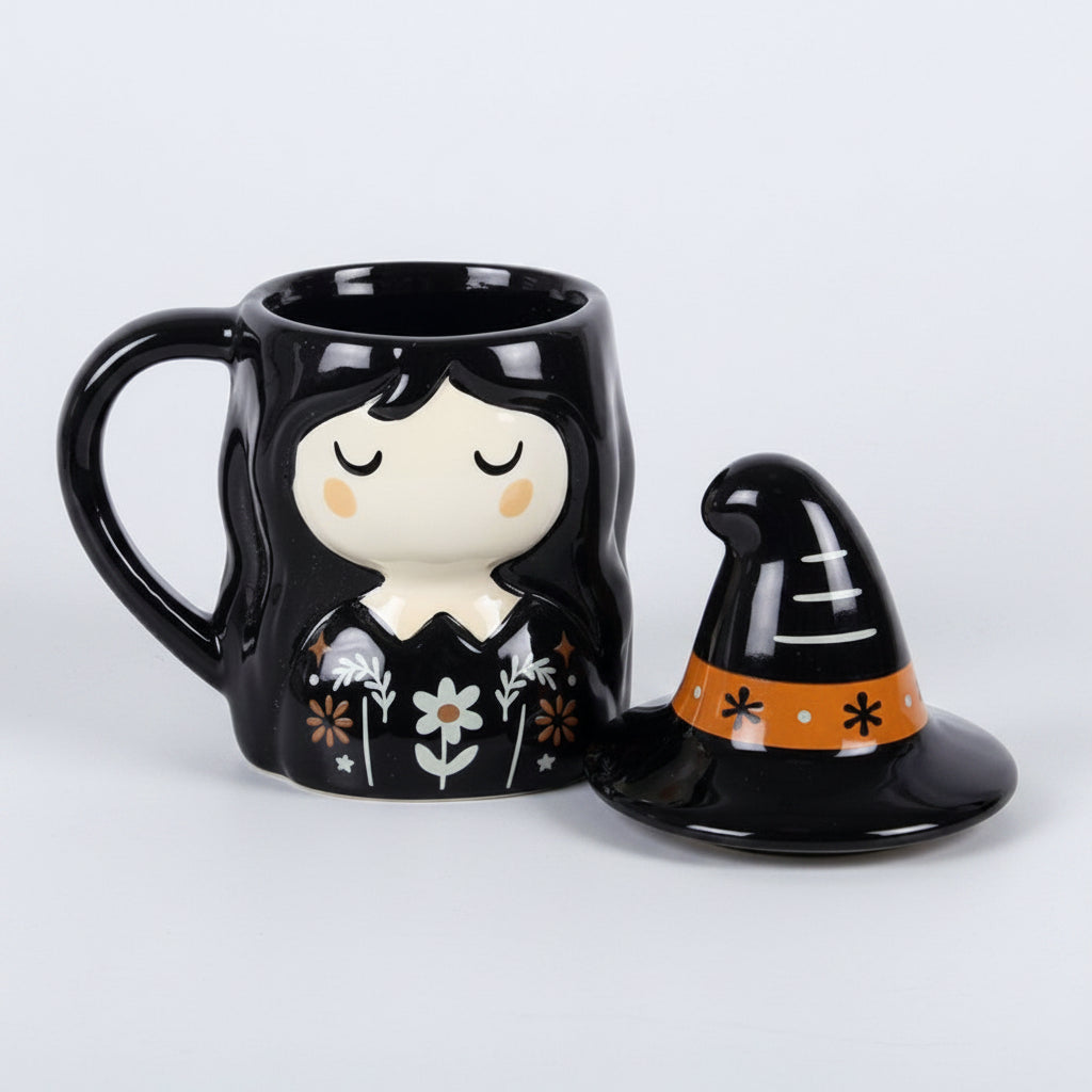 Black mug with a witch design and matching witch hat lid on a grey background