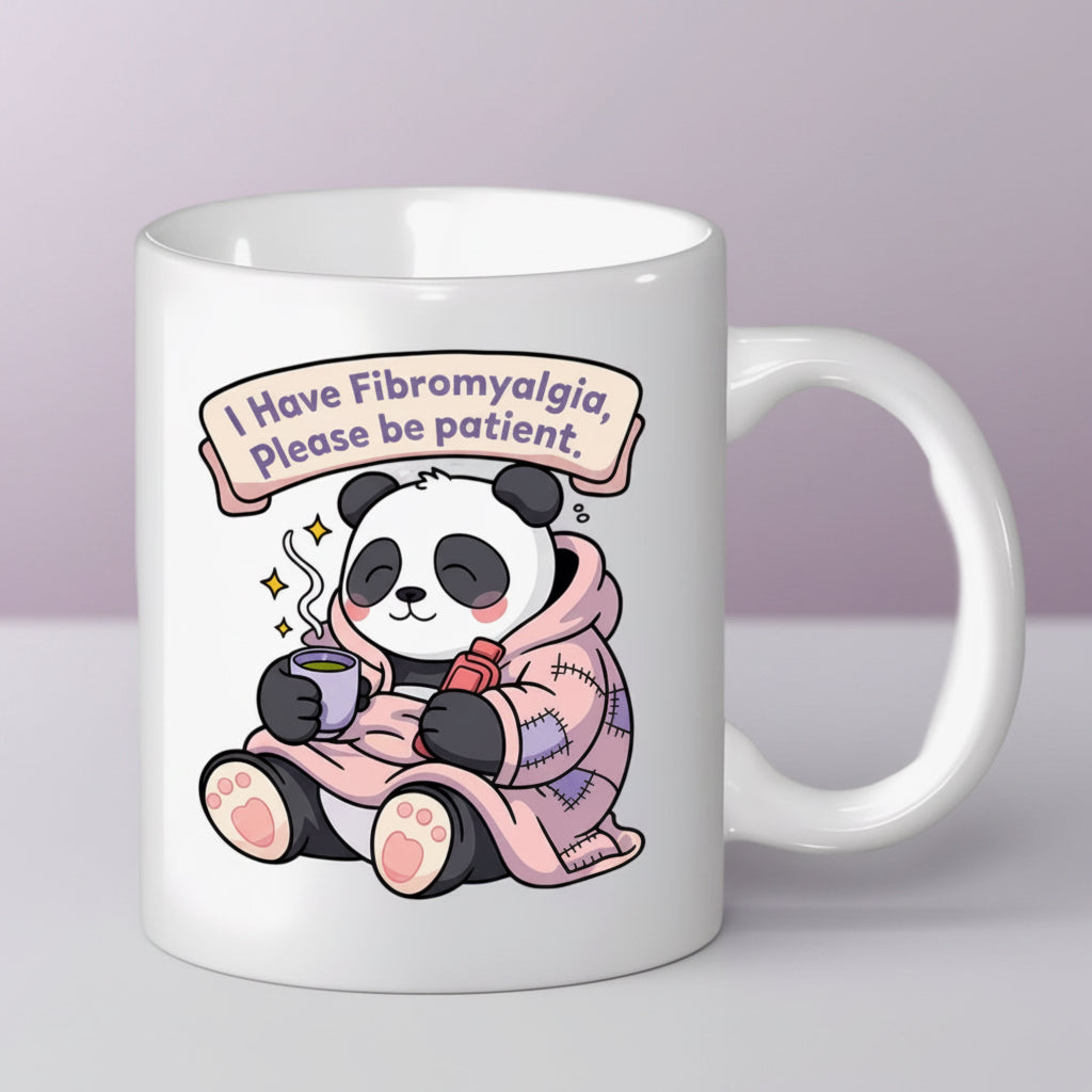 White mug with a panda design and text about fibromyalgia on a lilac  background