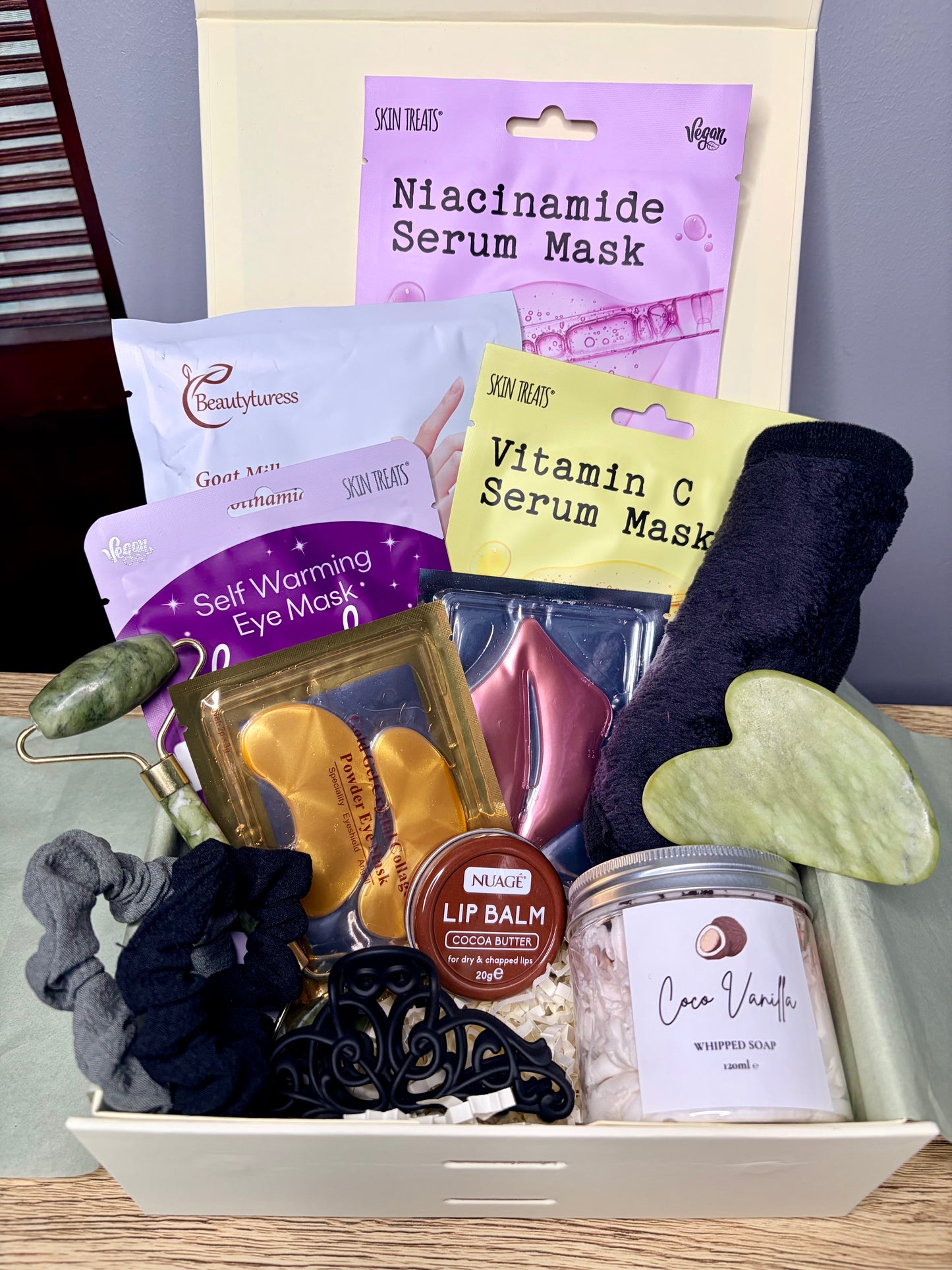 curated gift box filled with sheet masks, eye masks, lip mask and balm, face cloth, whipped soap, hair clip and scrunchies. 