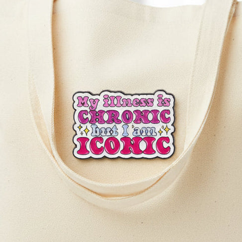 pin badge with text 'My illness is CHRONIC but I am ICONIC' on a beige background