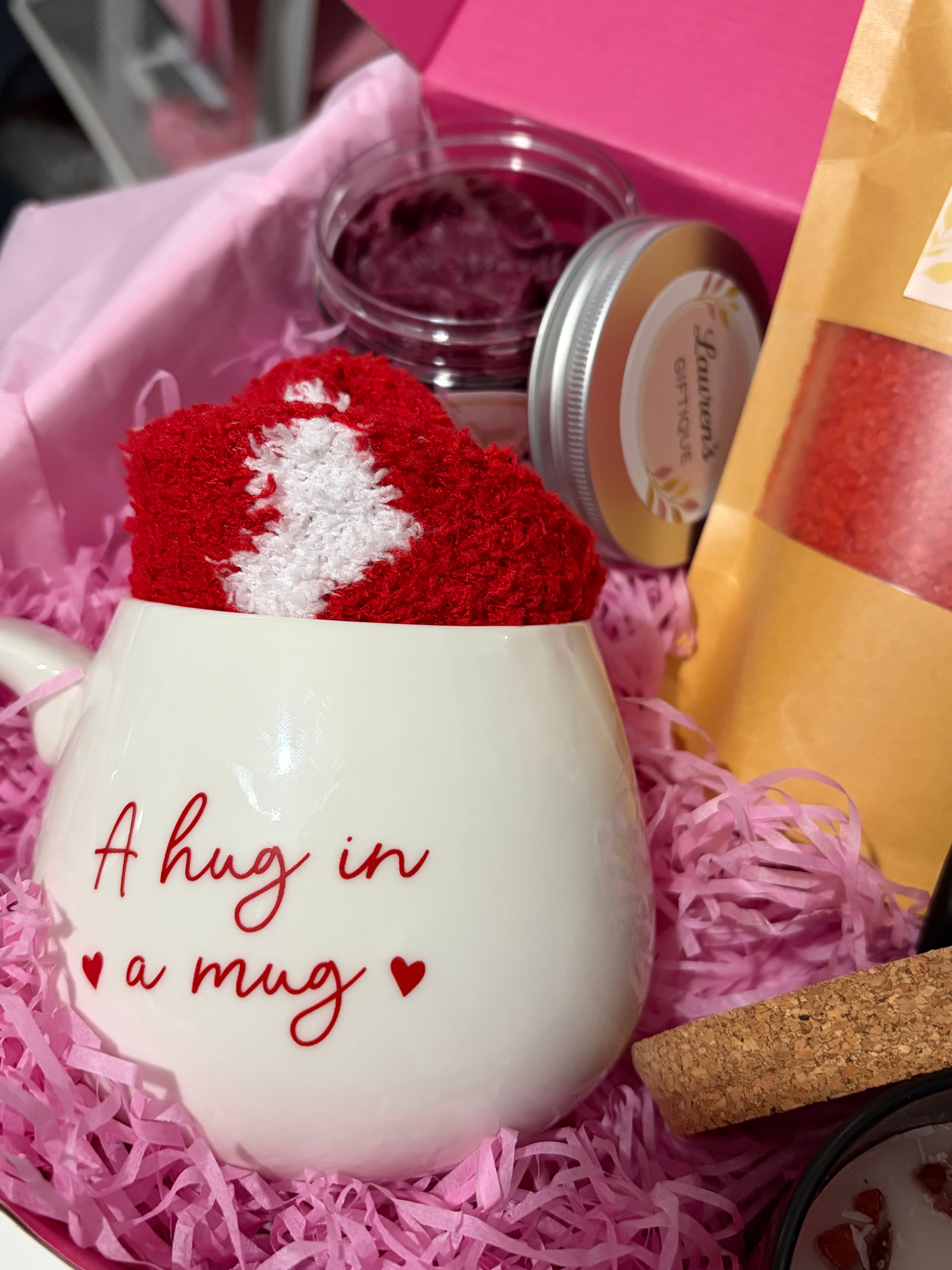 white mug with 'hug in a mug' text and cosy socks with whipped soap.