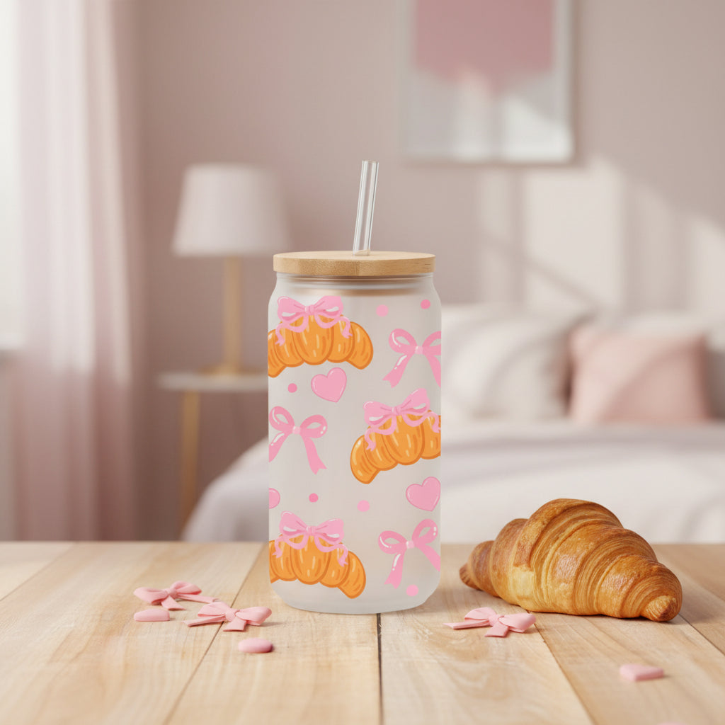 glass with croissants and pink bows on a table with croissant and home background