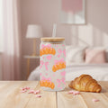 glass with croissants and pink bows on a table with croissant and home background