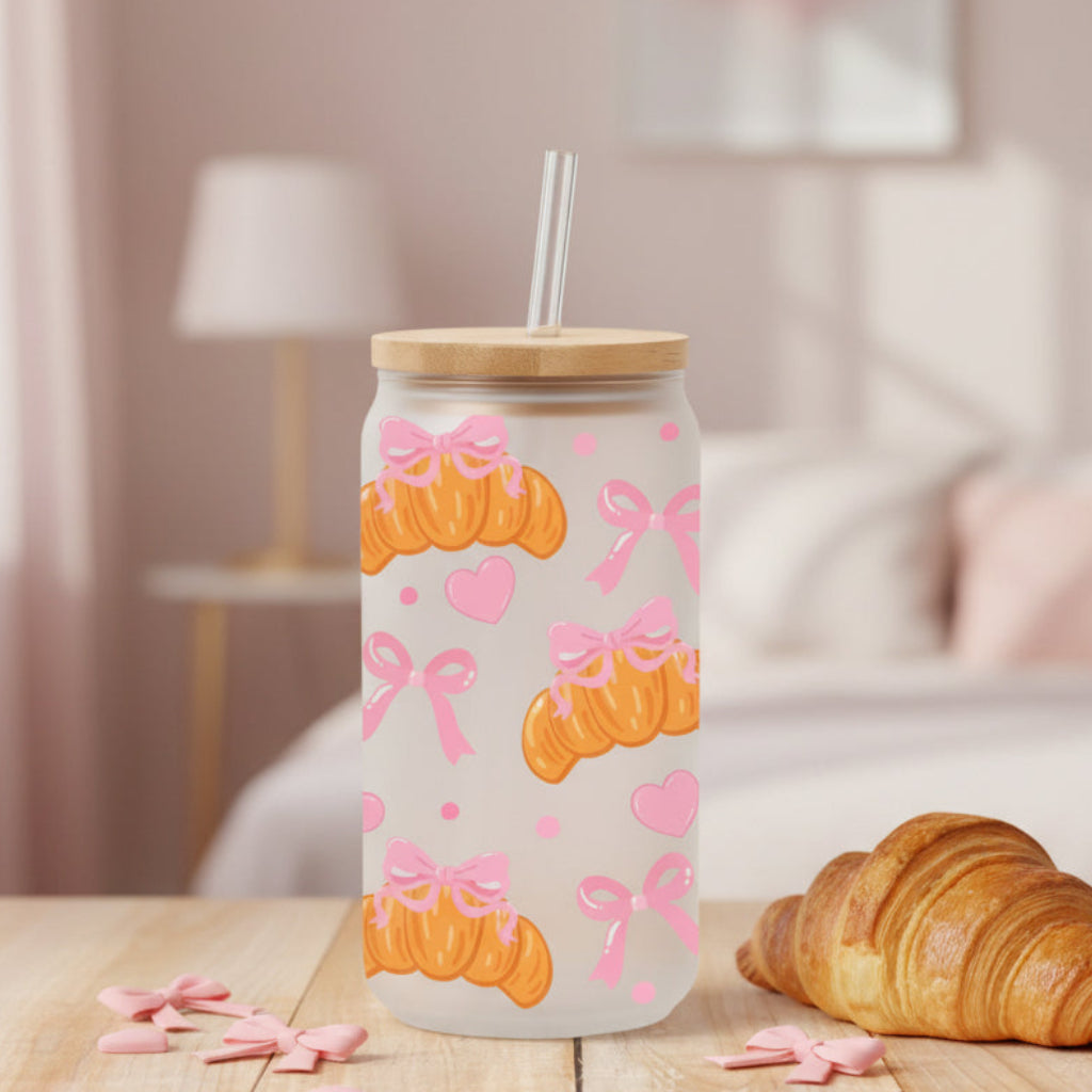 glass with croissants and pink bows on a table with croissant and home background