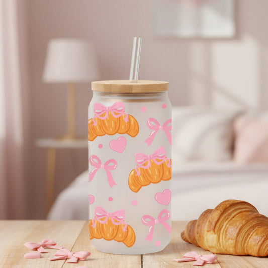 glass with croissants and pink bows on a table with croissant and home background