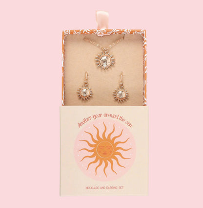 Necklace and earrings set in a decorative box with sun design
