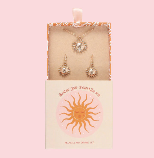 Necklace and earrings set in a decorative box with sun design