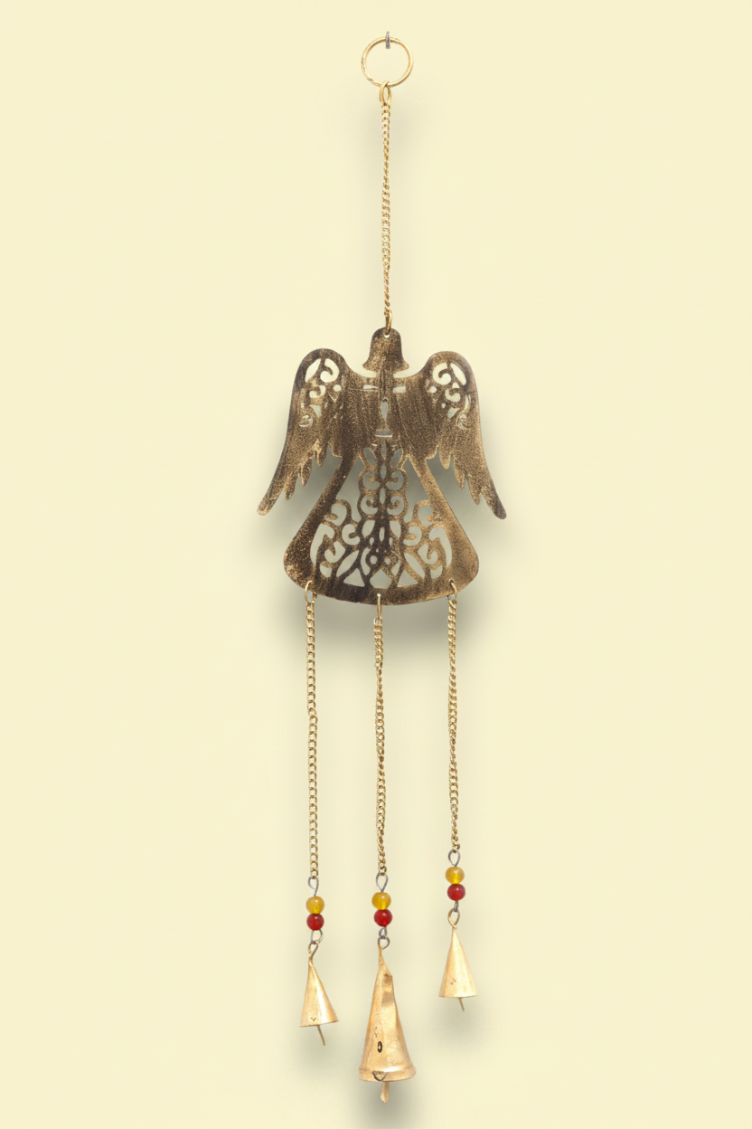 Decorative hanging angel with chains and bells on a yellow background