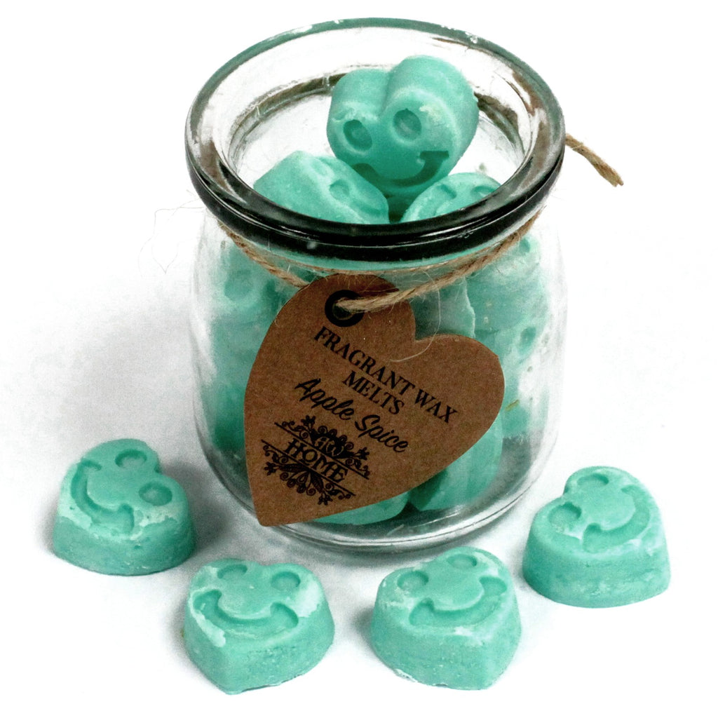 Jar of teal wax melts with a heart-shaped tag on a white background