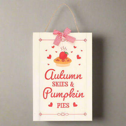 Decorative sign with a pumpkin pie illustration and text 'Autumn Skies & Pumpkin Pies' on a white background.