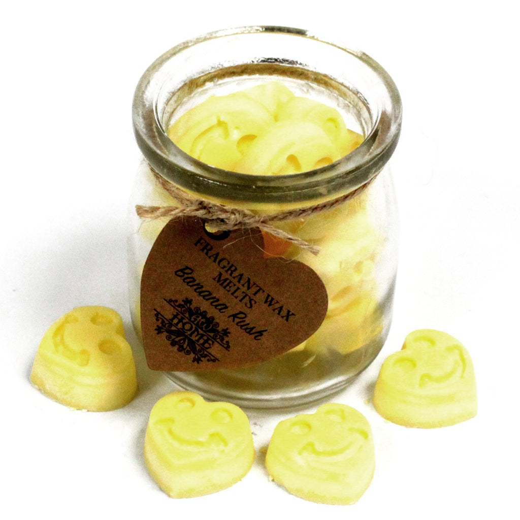 Jar of banana rush scented wax melts with a heart-shaped tag on a white background