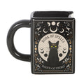 Black mug with a cat illustration and text on a white background