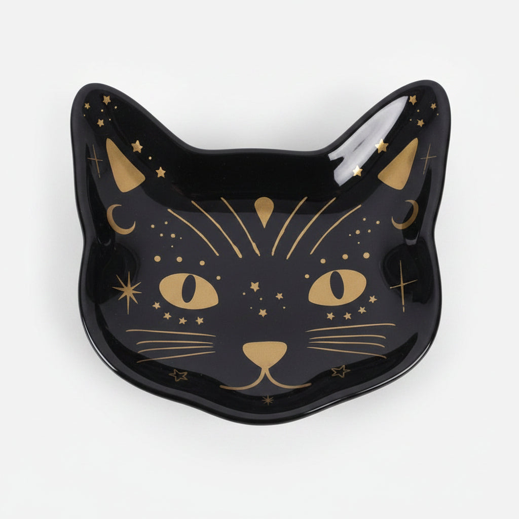 Black cat-shaped dish with gold accents on a grey background