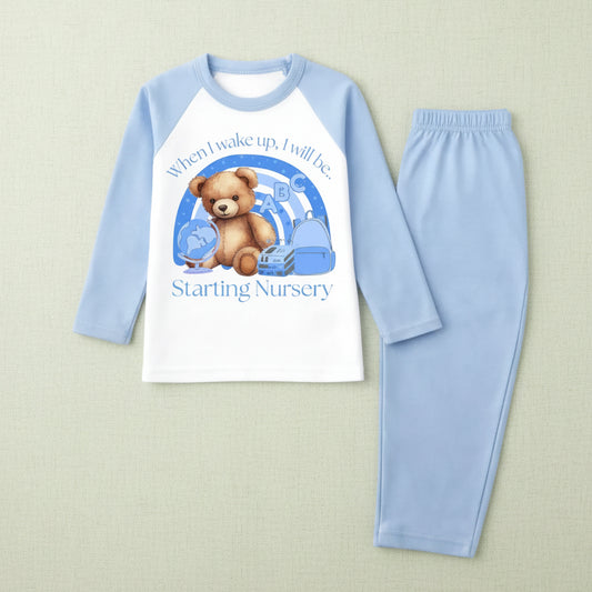 Children's pajama set with teddy bear design and text on a sage/ivory background