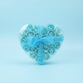 Bouquet of blue roses with a polka dot ribbon on a blue background
