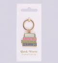 Book-themed keychain on a white card with 'Book Worm Enamel Keyring' text.