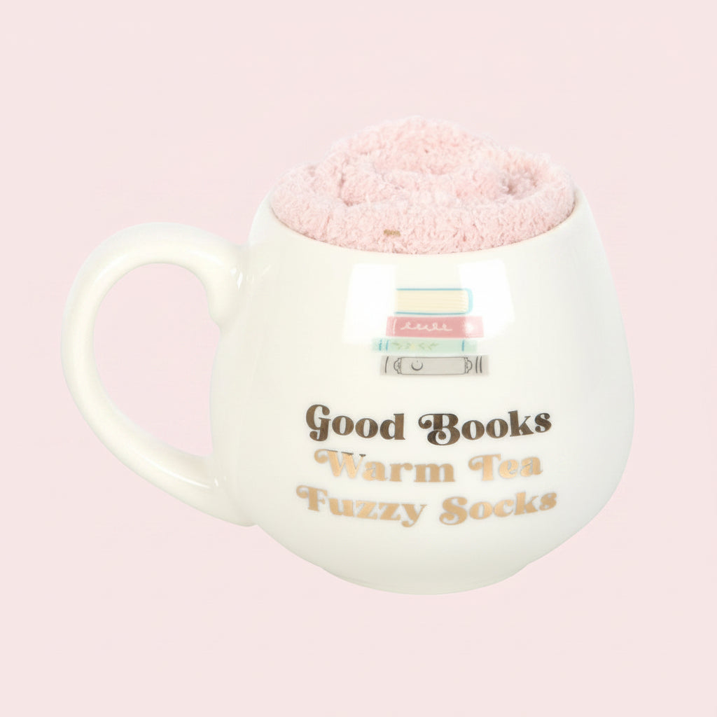 White mug with pink fuzzy socks, text 'Good Books Warm Tea Fuzzy Socks' on a pink background