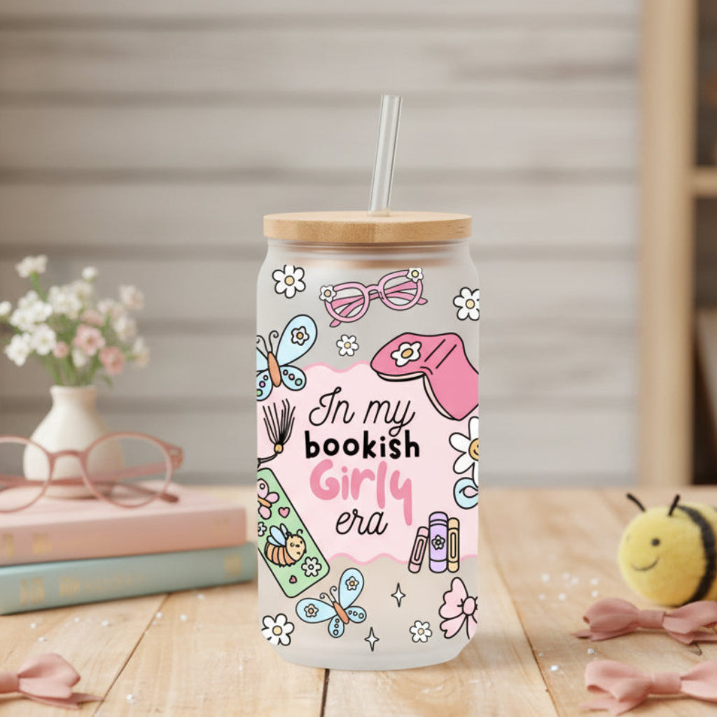 glass can with 'in my bookish girly era' design on a table with books and decor