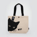 Beige tote bag with a black cat face design and 'WTF?' text on a white background