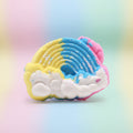 Colorful rainbow cloud-shaped bath bomb on a multicolour background