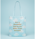 Light blue tote bag with motivational quote on a blue background