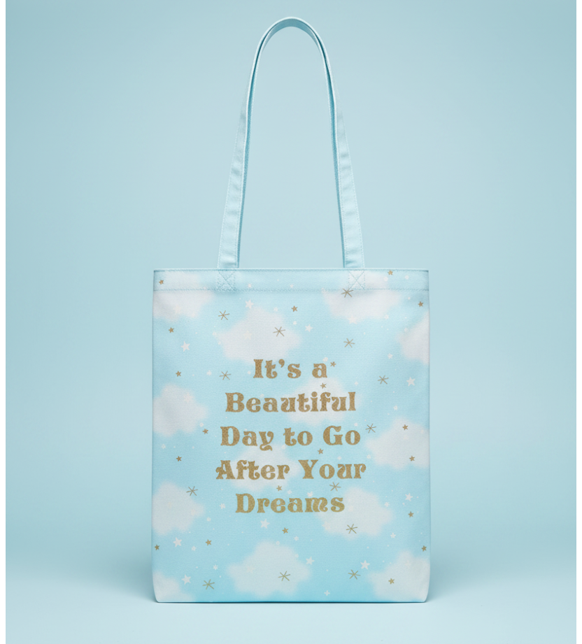 Light blue tote bag with motivational quote on a blue background
