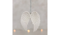 White angel wings hanging against a light gray background