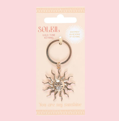 Keychain with sun design on a packaging with 'Soleil' branding.