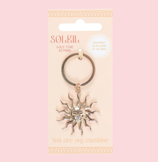 Keychain with sun design on a packaging with 'Soleil' branding.