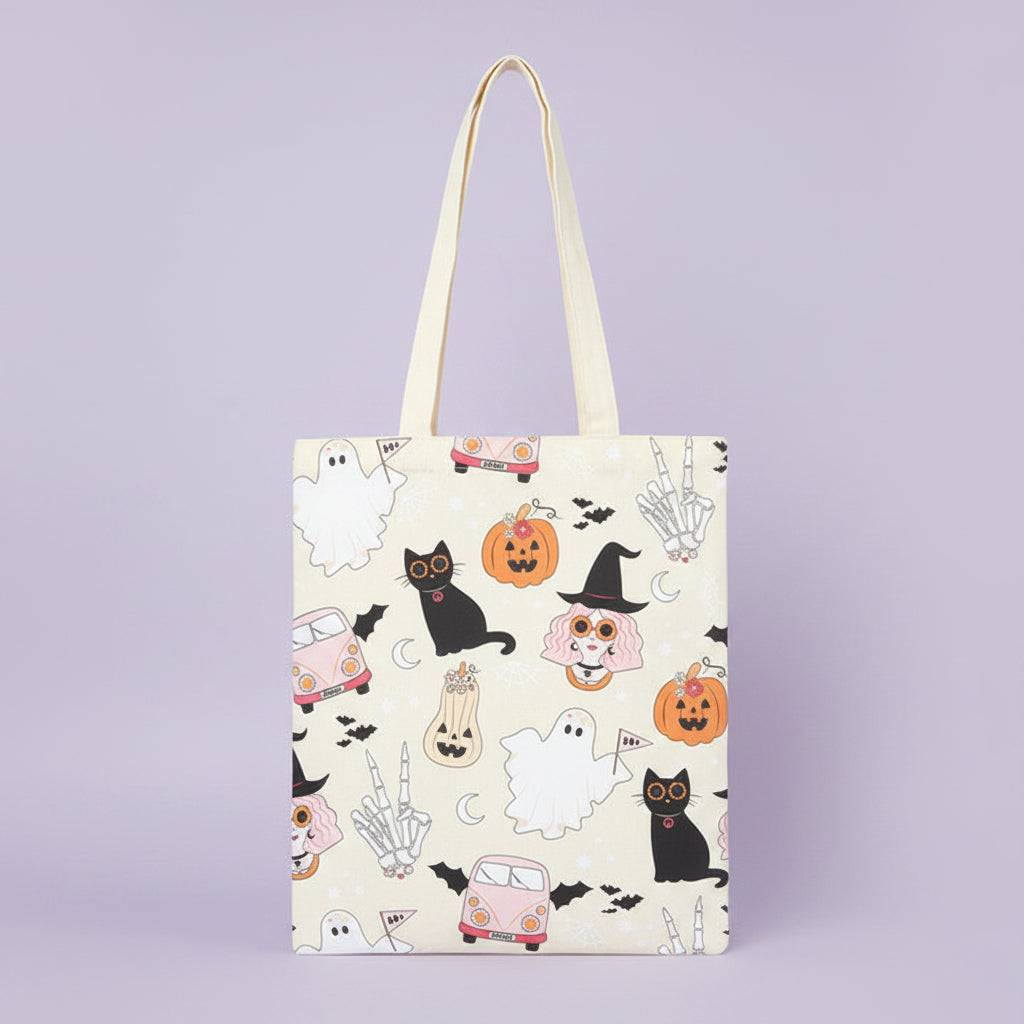 tote bag with witch, ghosts, cats and pumpkins on a purple background