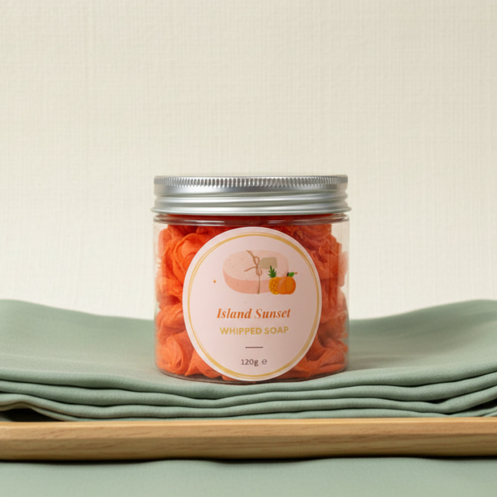 Jar of Island Sunset whipped soap on a contrasting background