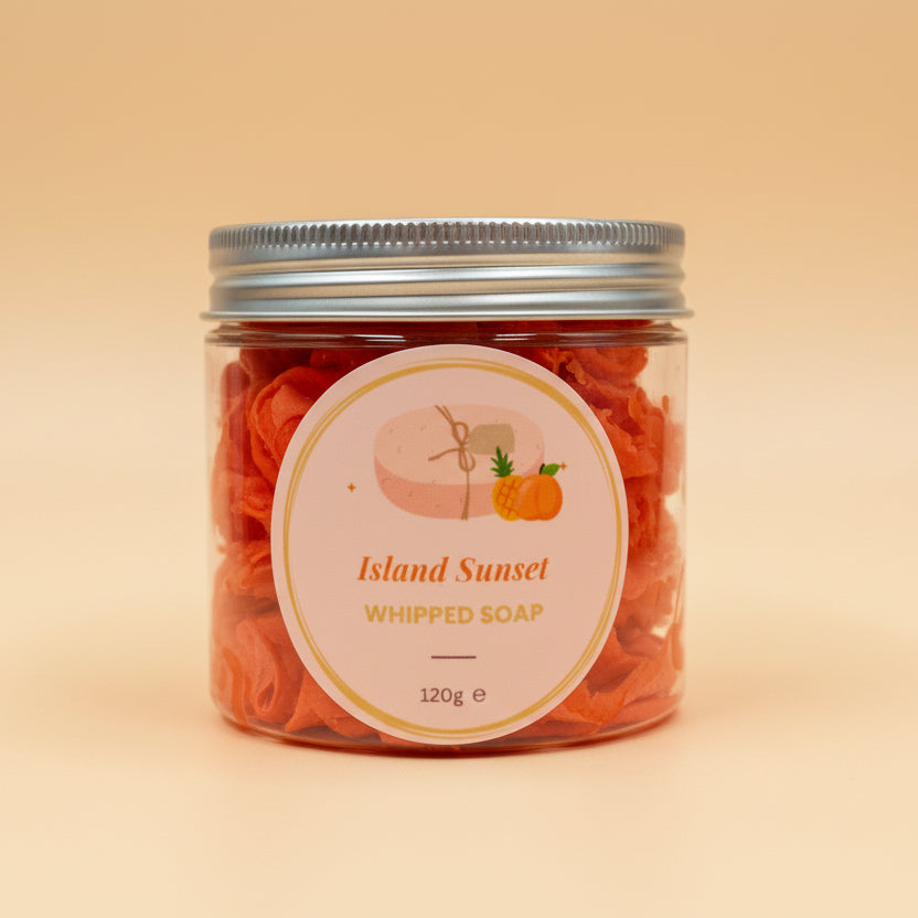 Jar of Island Sunset whipped soap on a contrasting background