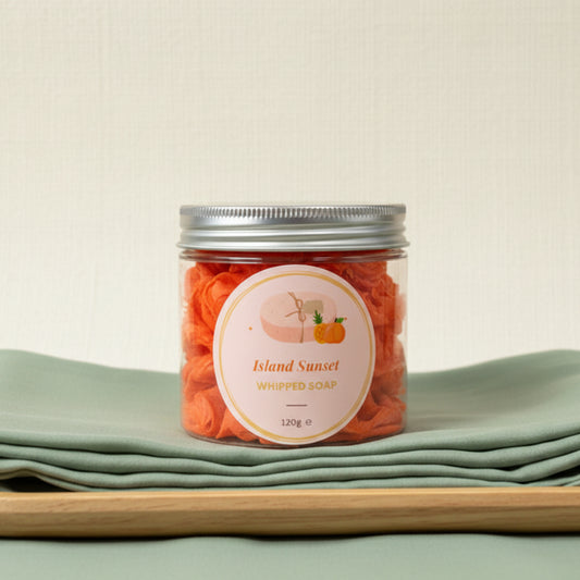 Jar of Island Sunset whipped soap on a contrasting background