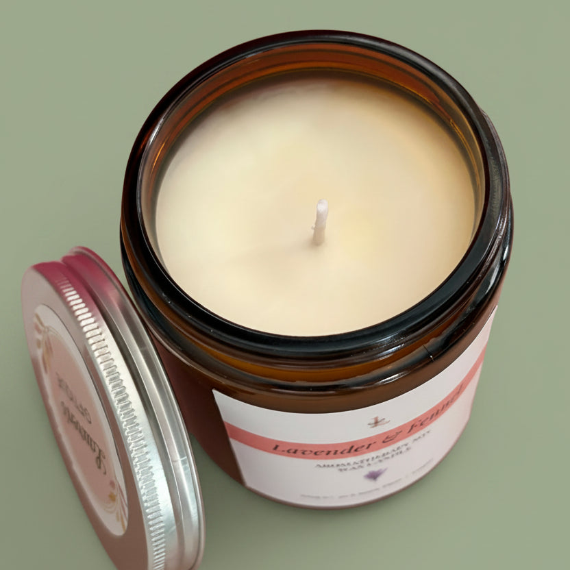Candle in a glass jar with a label on a pink background
