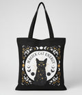 Black tote bag with a cat illustration and 'Magick Cat Energy' text on a grey background