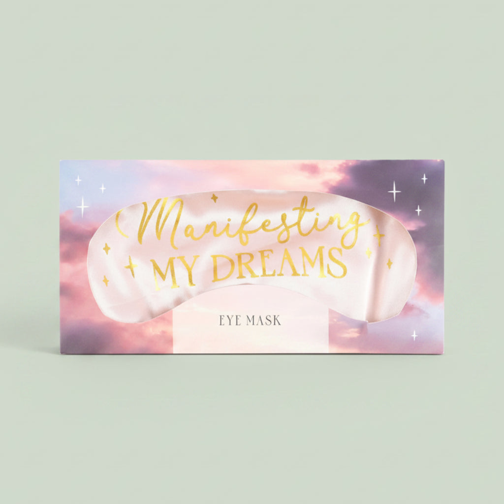 Eye mask with 'Manifesting My Dreams' text on a pastel background
