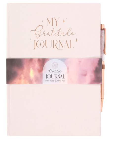 Gratitude journal with pink cover and rose gold accents on a white background