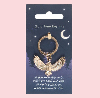 Gold tone keyring with owl design on a blue card with celestial illustrations