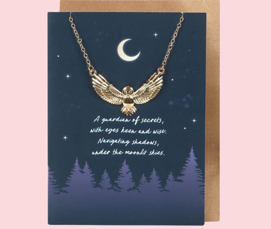 Necklace with owl design on a card with a night sky and trees illustration.
