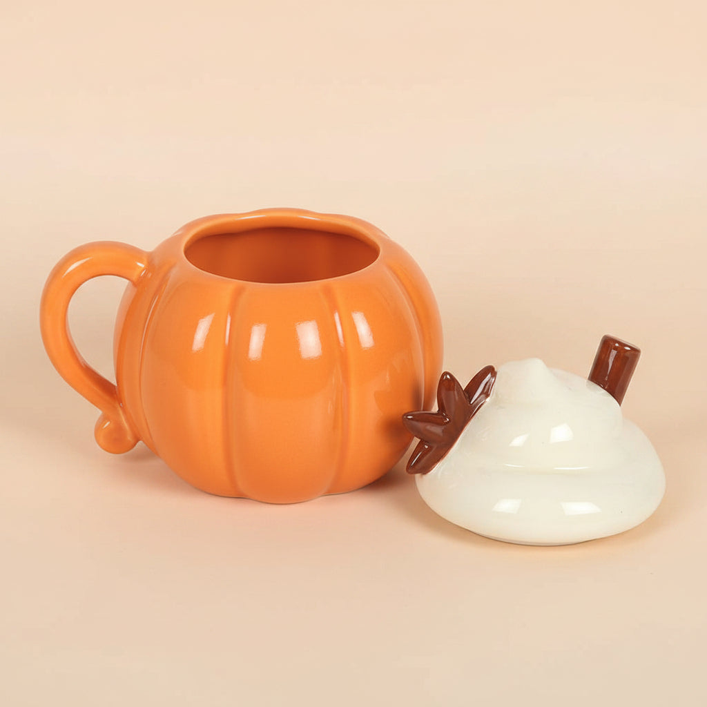 Pumpkin-shaped mug with a lid on a orange background