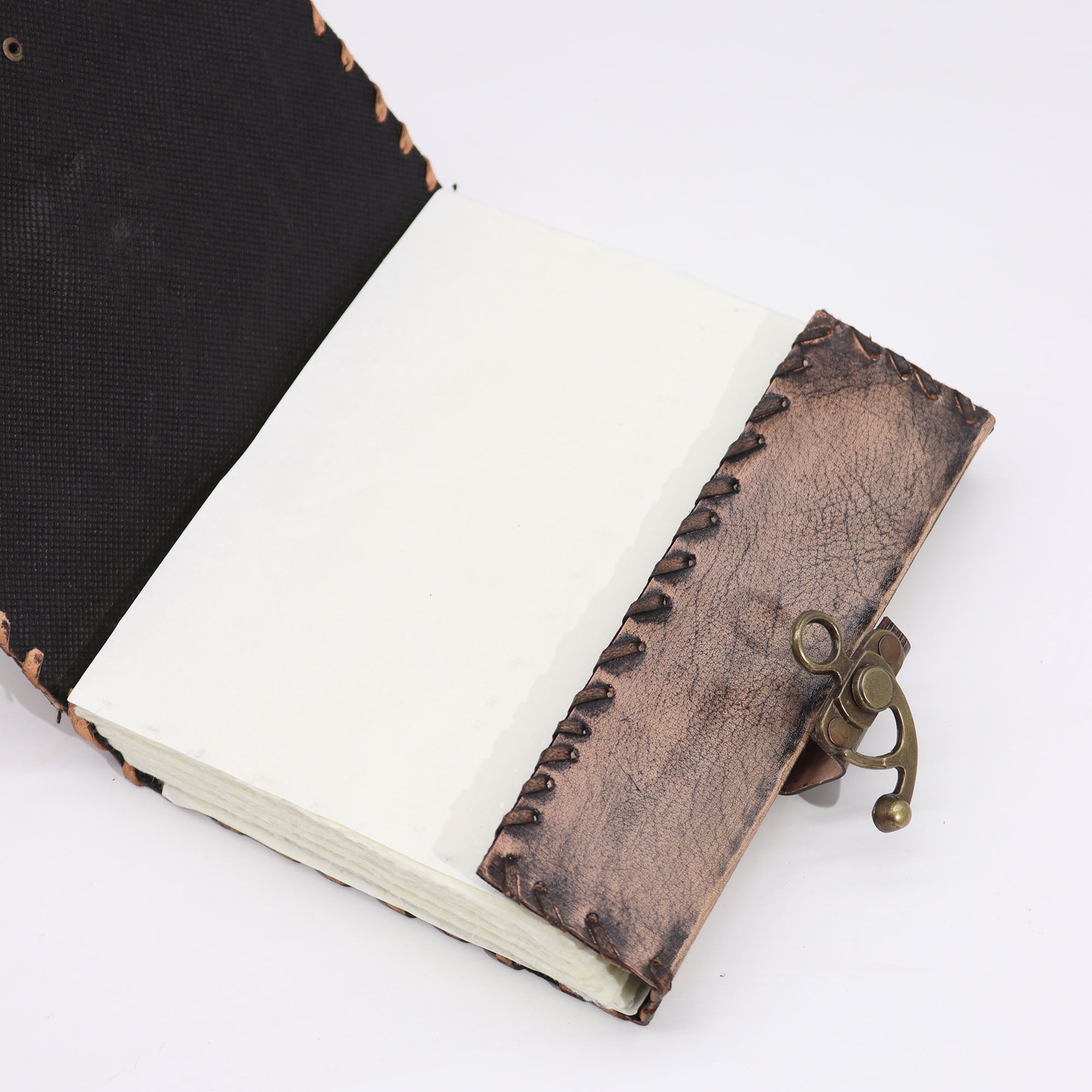 Handmade leather-bound notebook with a metal clasp on a white background
